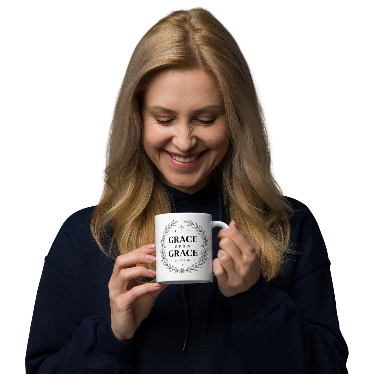 Woman smiling while holding Grace Upon Grace white ceramic mug – John 1:16 faith mug by RavnCo.